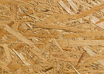 OSB sheet is made of brown wood chips pressed together into a wooden floor
