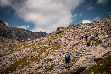 People hiking on a trail in High Tatras