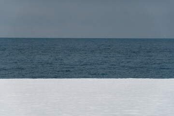 Winter sea. Snowy beach. White and blue.