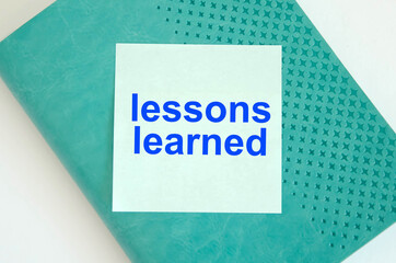  text it lessons learned with you available written on a blue background and notepad