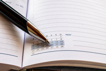 pen indicating date on calendar in the agenda