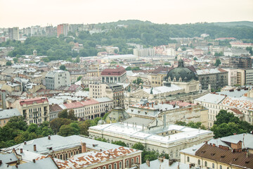 Fototapeta na wymiar top view from city hall tower on old town rooftops with restaurant in Lviv city