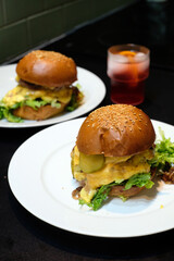 Delicious homemade beefburger with freshly baked sesame seed bun and pickles