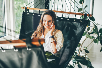Businesswoman working on a hammock. Freelancer and her workspace.