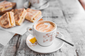 Traditional Portuguese breakfast - coffee with milk and a sandwich