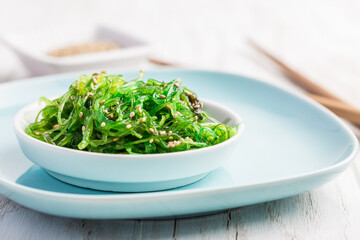 Traditional Japanese wakame salad with sesam seeds. Healthy seaweed salad.
