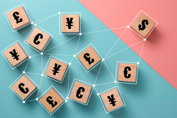 US dollar sign print screen to wooden cube and link with yuan yen euro and pound sterling. Currency exchange and forex concept.