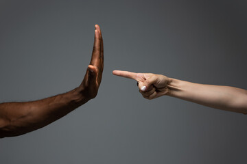 Plakat Stop racism. Racial tolerance. Respect social unity. African and caucasian hands gesturing on gray studio background. Human rights, friendship, intenational unity concept. Interracial unity.