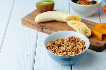 Bowl with granola on wooden table close up