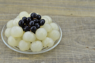 Fresh longan, remove seeds on wooden background