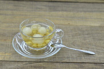 Lotus tea, longan in cup delicious on wooden table