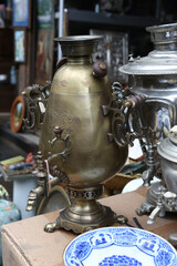 Ancient samovar on Izmaylovsky Vernissage, flea market in Moscow city. Antique souvenir from Russia in russian traditional national folk style. Antiquarian goods