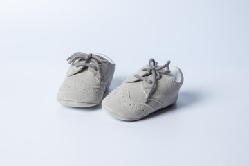 Baby boy shoes, shower invitation concept on pastel white background, banner, copy space, top view