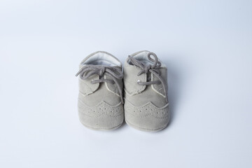Baby boy shoes, shower invitation concept on pastel white background, banner, copy space, top view