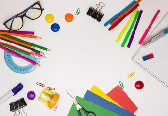 Office supplies in the form of a frame, free space for text, white background, top view.