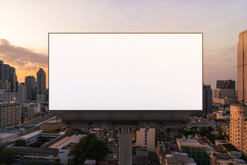 Blank white road billboard with Bangkok cityscape background at sunset. Street advertising poster, mock up, 3D rendering. Front view. The concept of marketing communication to promote or sell idea.