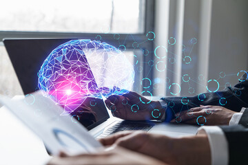 Two business people working together on IT project. Brainstorm concept. brain hologram. Double exposure.