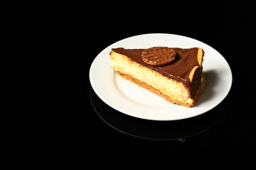 slice of Dutch chocolate covered pie on white plate on black reflective background