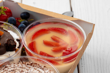 Jelly dessert with strawberry in a glass cup