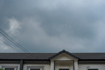 Dark sky while storm is coming over  home roof .