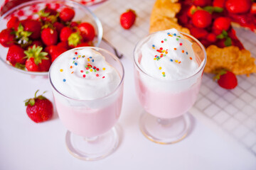 strawberry smoothie milk shake cocktail with whipped cream.