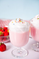 strawberry smoothie milk shake cocktail with whipped cream.