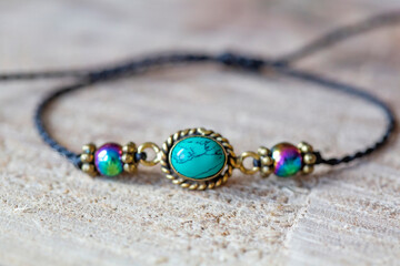 Turquoise and hematite mineral stone beads bracelet on wooden background