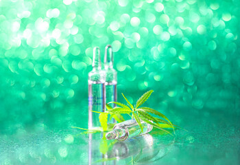 Ampoules on a beautiful bokeh background. Concept of using cannabis herb and leaves for treatment. . Alternative treatment. Natural cosmetics. Cosmetology injections.