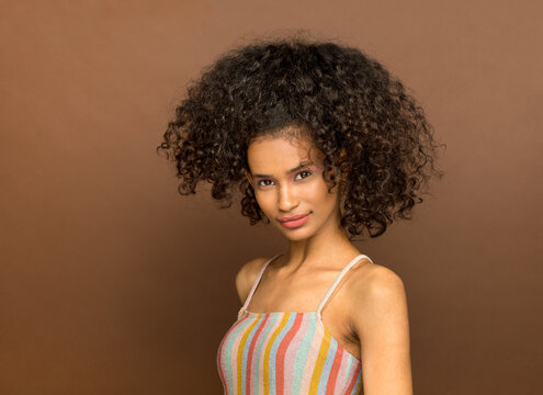 Cute young black woman with curly afro hairstyle