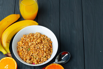 Bowl with granola on wooden table close up