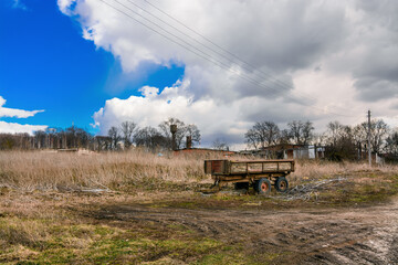 Wooden cart near dry grass field