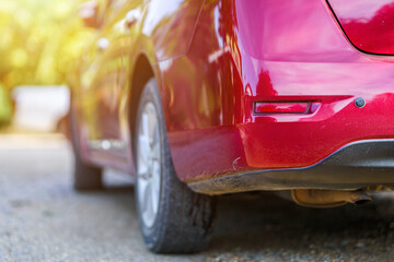 Close-up rear car get scratched of Red auto or automobile motor car of shiny convertible luxury outside background,transportation trip concept