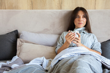 Good morning! Woman woke up in bed. Woman drinking coffee in bed