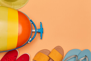 Family trip. Summer time. Travelling and vacation concept. Top view of travelling bag, sun hat and shoes. Copy space