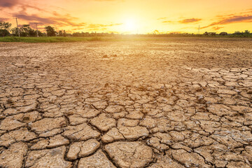 Brown dry soil or cracked ground texture on blue sky background with white clouds sunset,Global warming