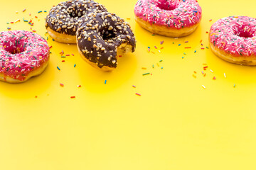 Colorful donuts close up, glazed and sprinkles bakery
