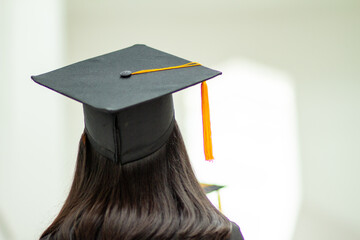 Picture of a black hat with yellow tassels from a university graduate.
