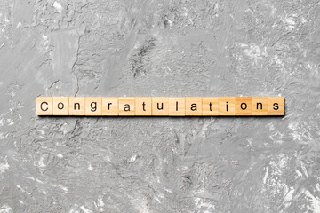 congratulations word written on wood block. congratulations text on cement table for your desing,...