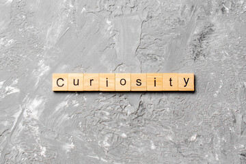 curiosity word written on wood block. curiosity text on table, concept