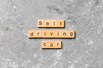 Self-driving car word written on wood block. Self driving car text on cement table for your desing, concept