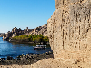 contrast of beautiful landscape and ancient history in aswan - obrazy, fototapety, plakaty