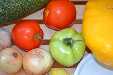 Autumn harvest. Green and red tomatoes, pumpkin, vegetable marrow, onions, garlic. Ingredients for vegetable vegetarian ragout. Organic farm food. Autumn natural vitamins. 
