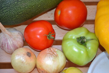 Autumn harvest. Green and red tomatoes, pumpkin, vegetable marrow, onions, garlic. Ingredients for vegetable vegetarian ragout. Organic farm food. Autumn natural vitamins. 