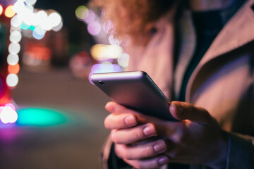 Young elegant woman using mobile phone
