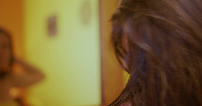 Woman out of the shower Combing hair
