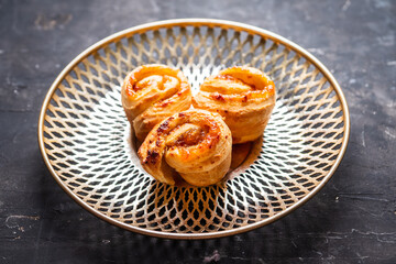 Fresh sweet bun with orange jam on the rustic wooden background. Selective focus.