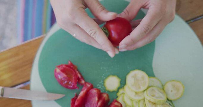 Woman cuts Tomato