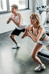Fototapeta na wymiar selective focus of young sport couple working out in gym
