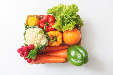 Fresh fegetables in basket box on white table background.
