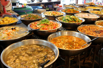 Various meals of vegetables, chicken, pork and spices in market